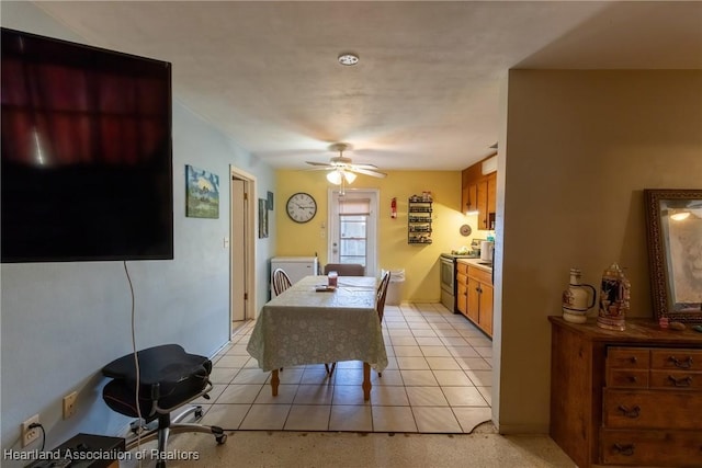 dining room featuring washer / dryer, a ceiling fan, and light tile patterned floors