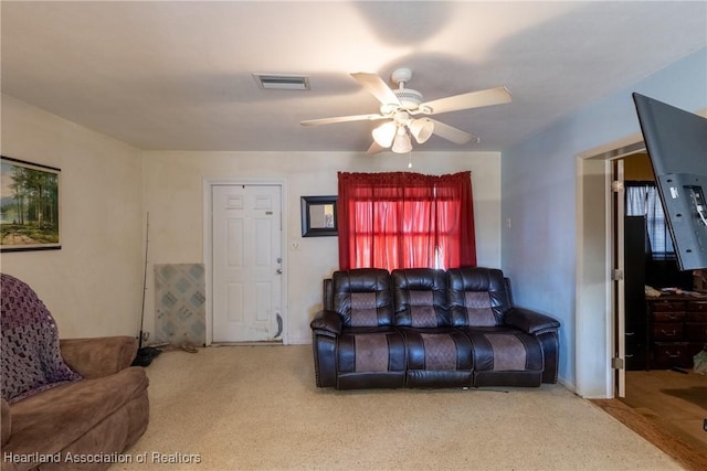carpeted living room featuring ceiling fan and visible vents