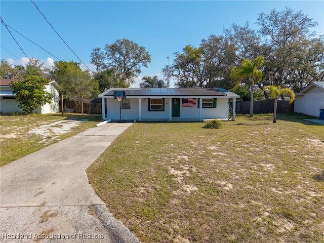 bungalow-style house featuring driveway, fence, and a front yard