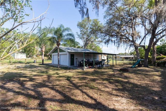 exterior space with an outdoor structure and a detached garage