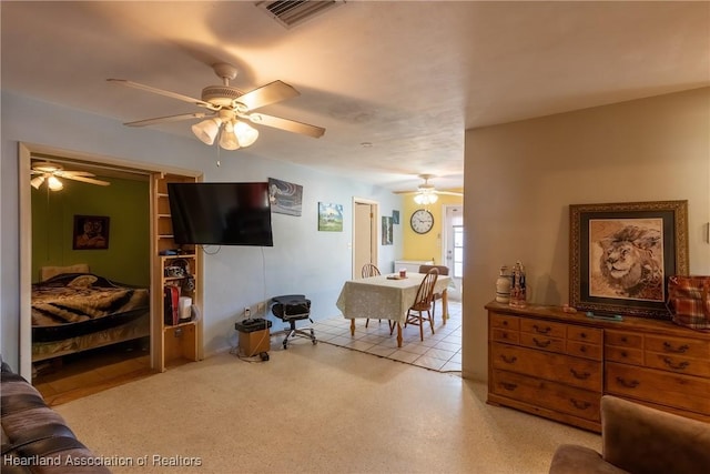 living room with a ceiling fan and visible vents