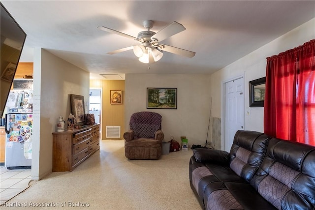 living room with light carpet, a ceiling fan, and visible vents