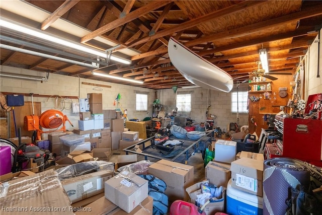 garage featuring concrete block wall and ceiling fan