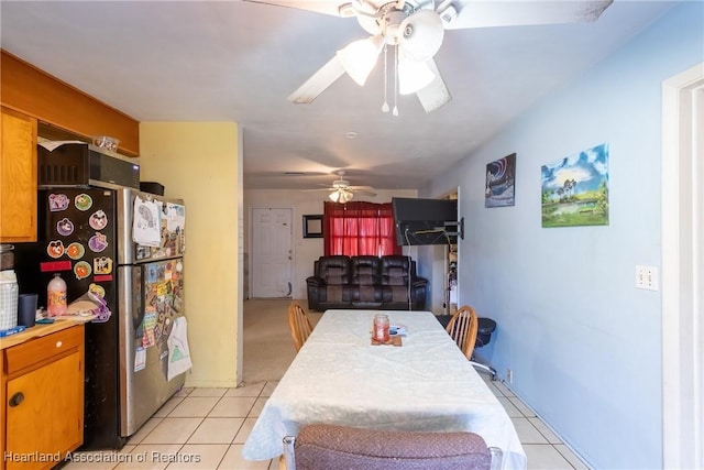 dining area with a ceiling fan and light tile patterned floors