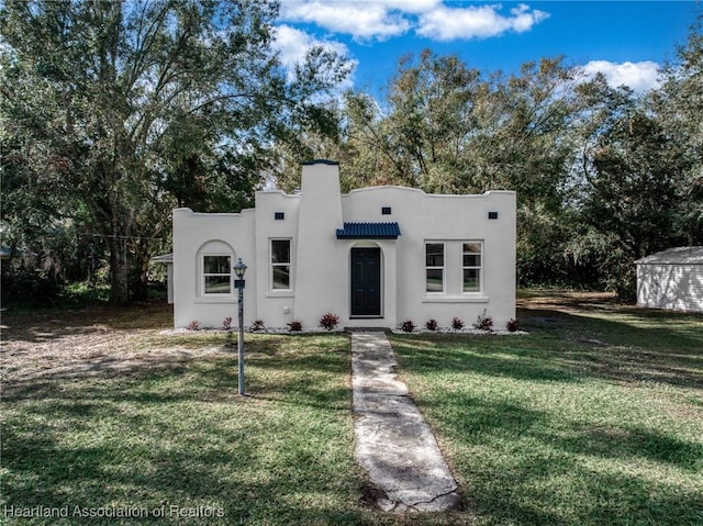 southwest-style home with a front lawn