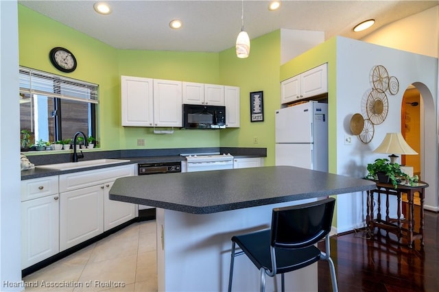 kitchen with white cabinets, white appliances, and sink