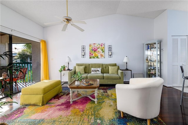 living room featuring ceiling fan, dark hardwood / wood-style flooring, and lofted ceiling