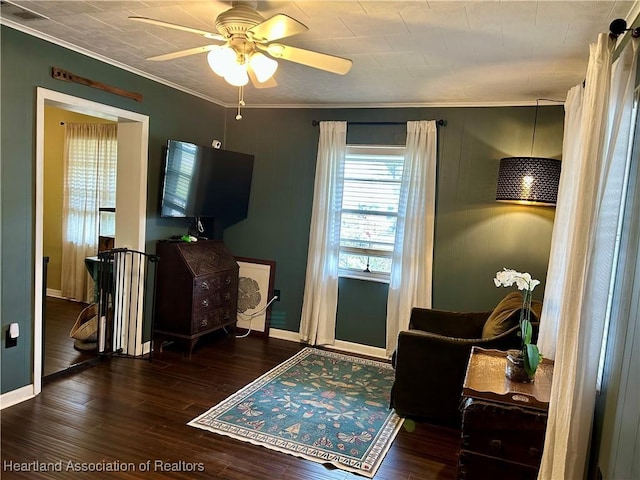 interior space with ornamental molding, ceiling fan, and dark hardwood / wood-style floors