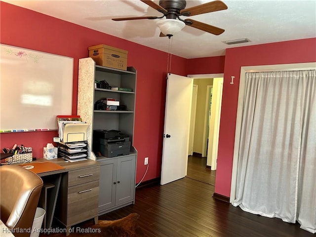 home office with ceiling fan and dark hardwood / wood-style flooring