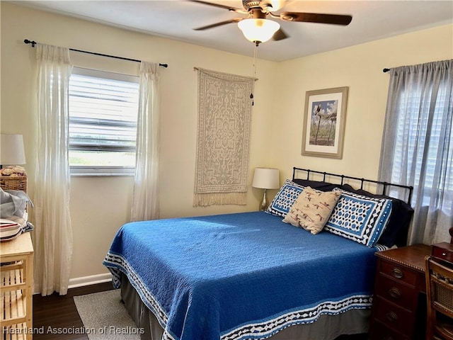 bedroom with ceiling fan and dark hardwood / wood-style floors