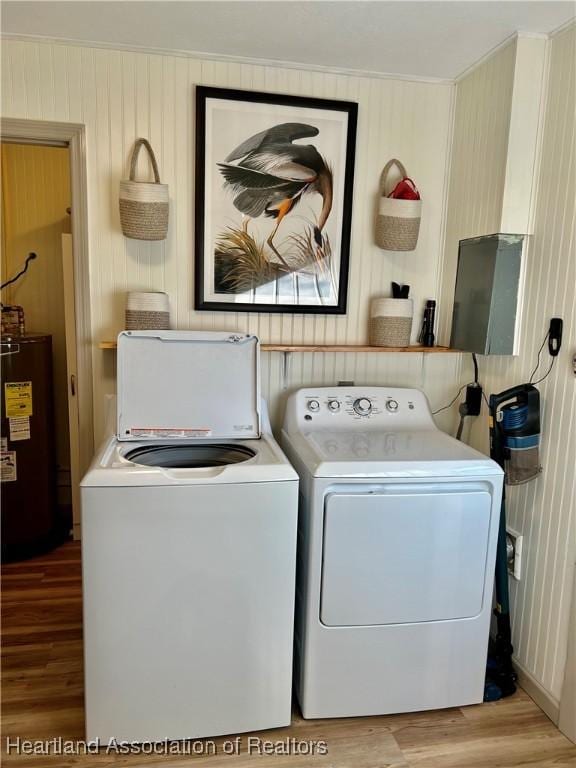 laundry area featuring separate washer and dryer, light hardwood / wood-style floors, and electric water heater