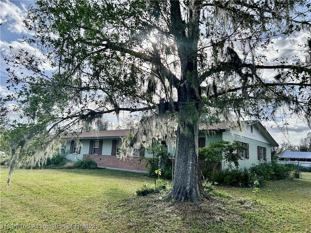 view of side of property with a lawn