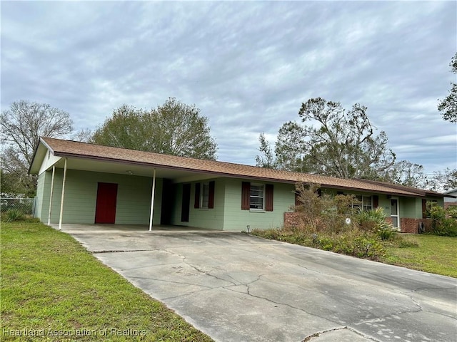 single story home with a front yard and a carport