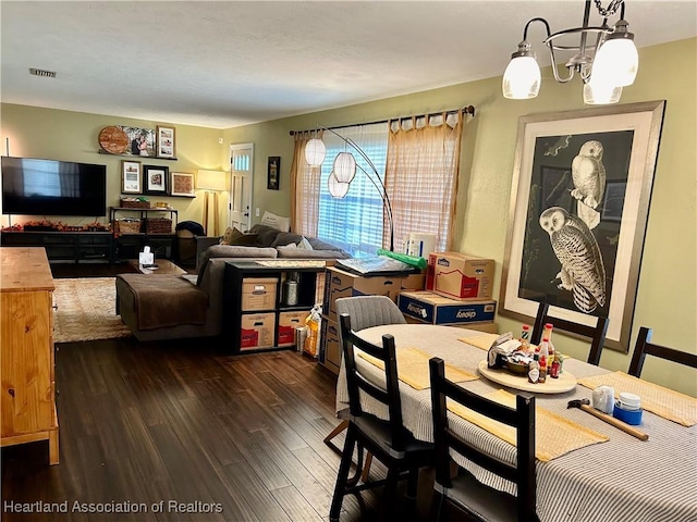 dining room featuring dark hardwood / wood-style flooring and a chandelier