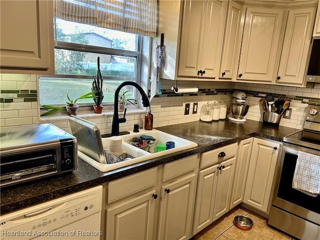 kitchen featuring white dishwasher, decorative backsplash, sink, stainless steel range with electric cooktop, and light tile patterned flooring