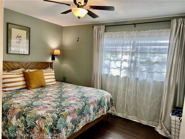 bedroom with ceiling fan and dark hardwood / wood-style floors