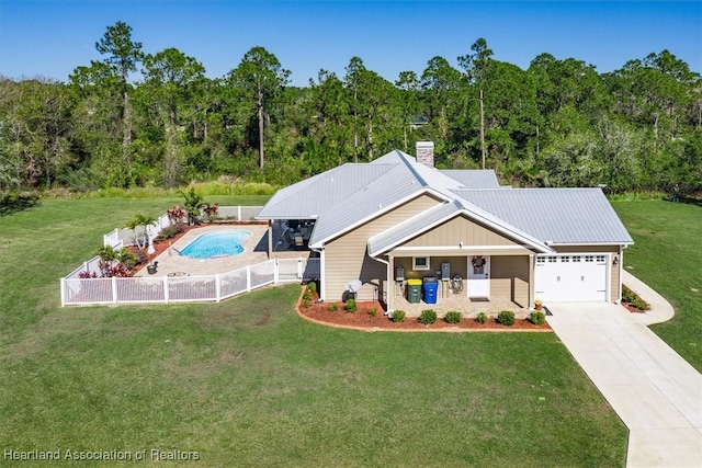 view of front of home with a garage and a front lawn