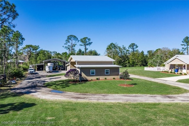 view of front of property with a front yard and a carport