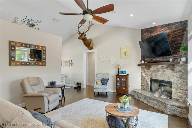 living room with dark hardwood / wood-style floors, ceiling fan, a fireplace, and high vaulted ceiling