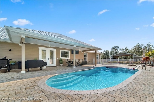 view of pool featuring a patio, french doors, and ceiling fan