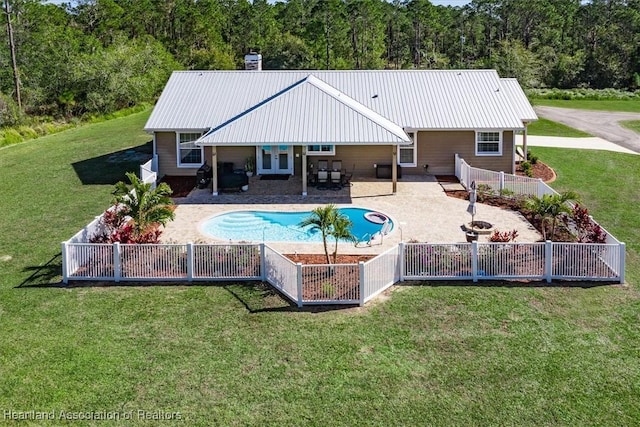 rear view of property featuring a lawn and a patio