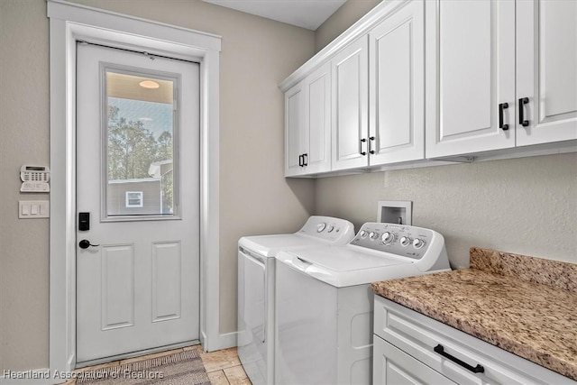 washroom with cabinets and separate washer and dryer