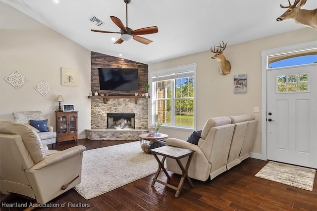 living room featuring lofted ceiling, a fireplace, dark hardwood / wood-style floors, and ceiling fan