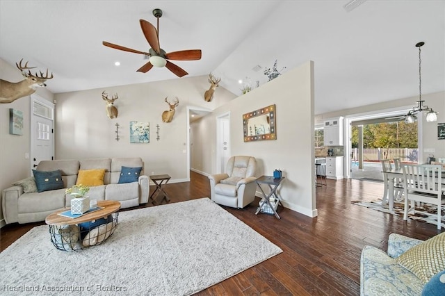 living room with vaulted ceiling, ceiling fan, and dark hardwood / wood-style flooring