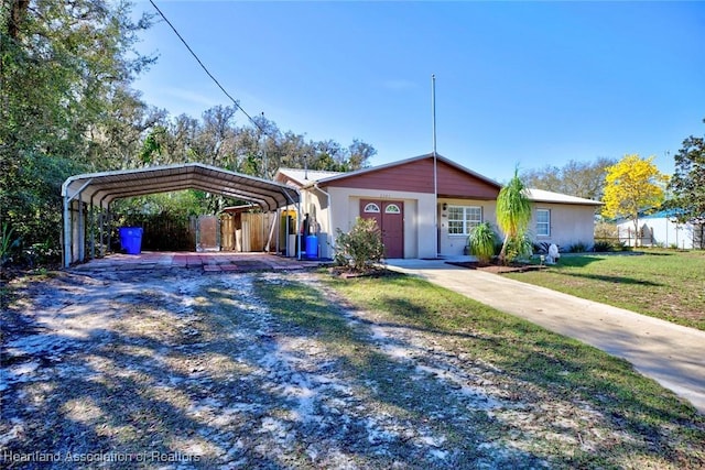 ranch-style house with a front lawn and a carport