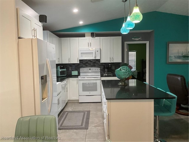 kitchen featuring white cabinets, white appliances, and vaulted ceiling