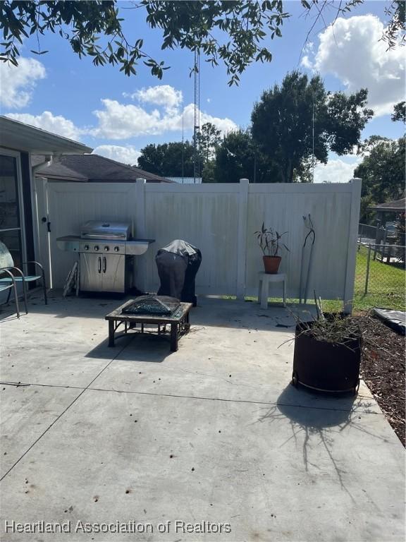 view of patio / terrace with an outdoor fire pit and grilling area