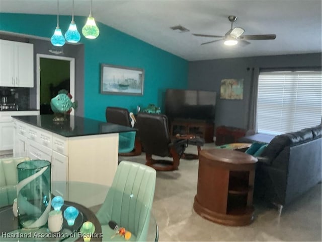 living room featuring ceiling fan and lofted ceiling