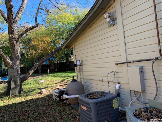 view of home's exterior with a lawn and central AC unit