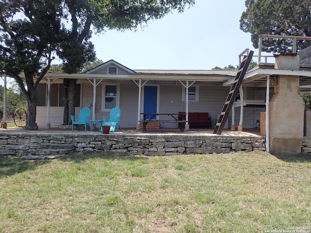 view of front of house featuring a front yard and a patio