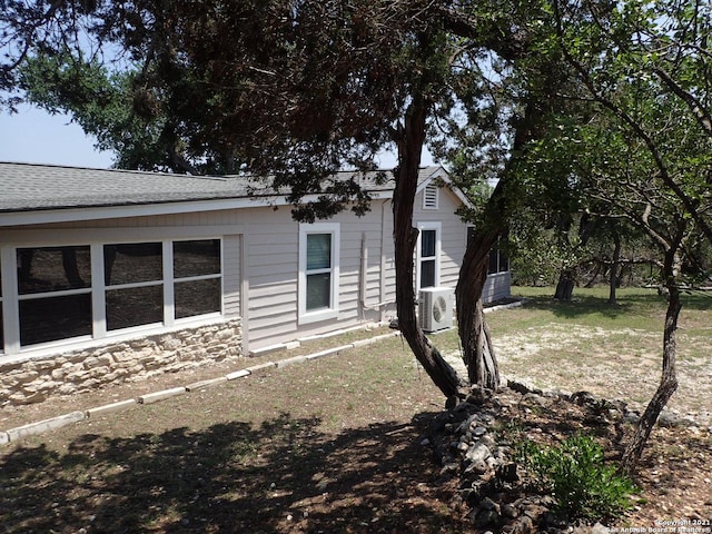 rear view of property featuring a lawn