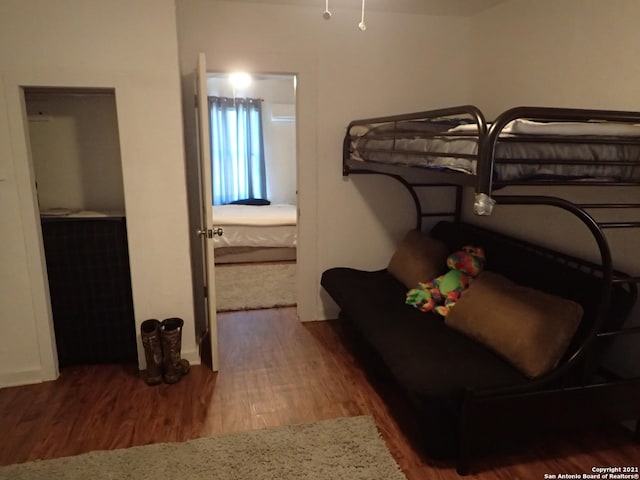 bedroom with dark hardwood / wood-style flooring