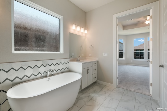 bathroom featuring ceiling fan, tile floors, large vanity, and a tub