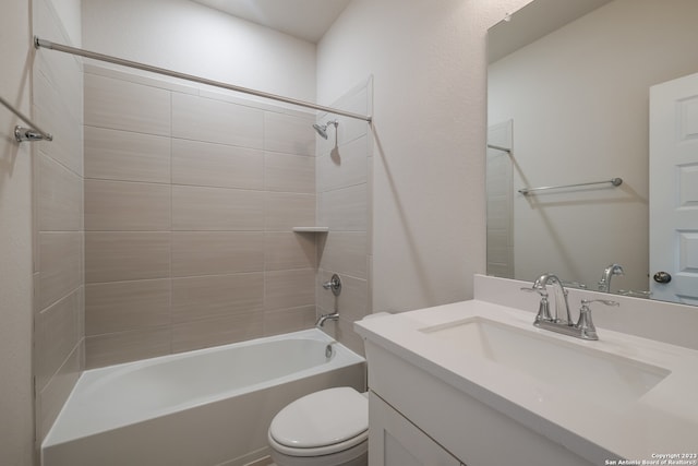 full bathroom featuring toilet, vanity, and tiled shower / bath