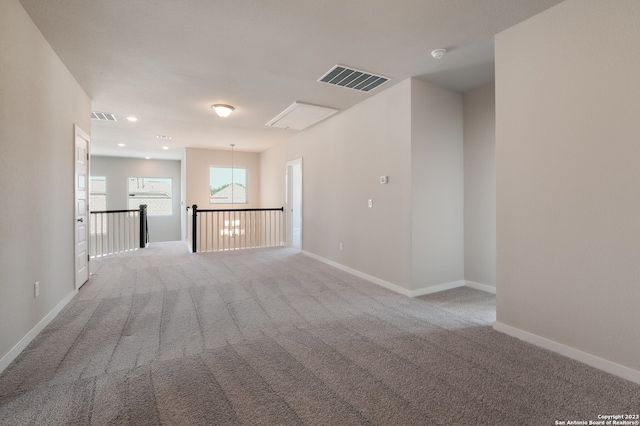 unfurnished living room featuring light colored carpet