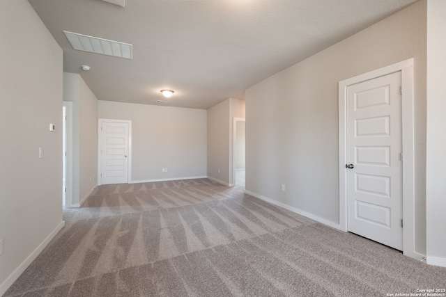 spare room with light colored carpet