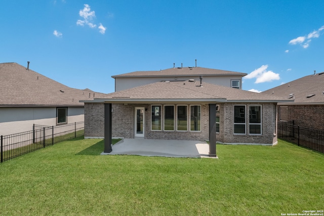 rear view of house with a patio and a lawn