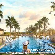 pool at dusk featuring a water view