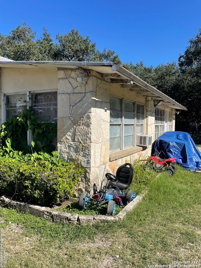 view of side of home with a yard