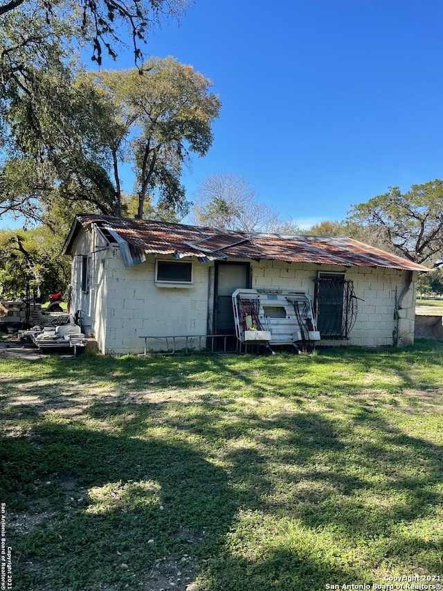 rear view of house with a yard