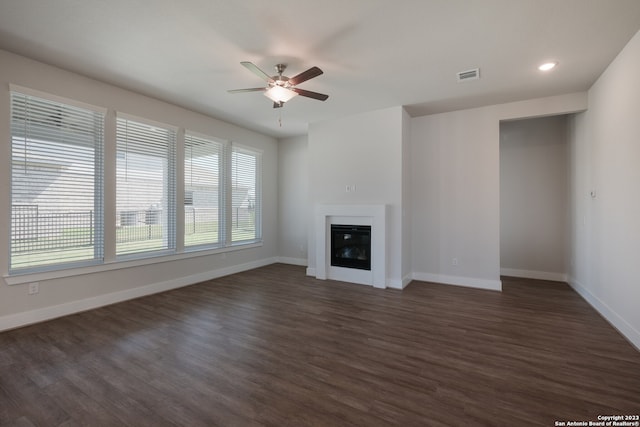 unfurnished living room with dark hardwood / wood-style floors and ceiling fan