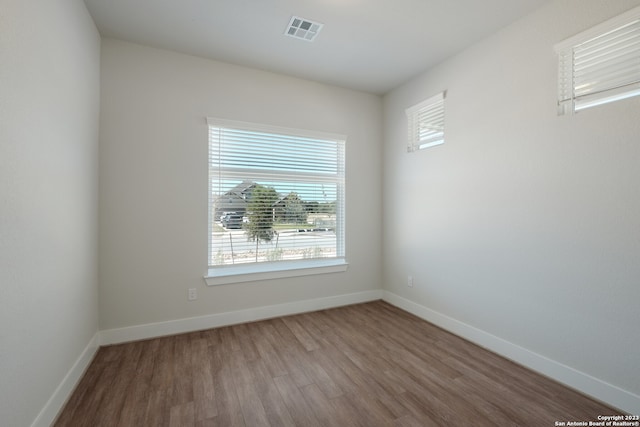 spare room with wood-type flooring