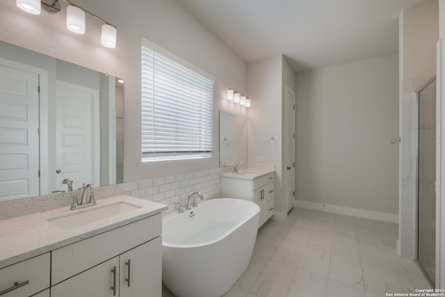 bathroom featuring a tub, plenty of natural light, tile flooring, and dual bowl vanity