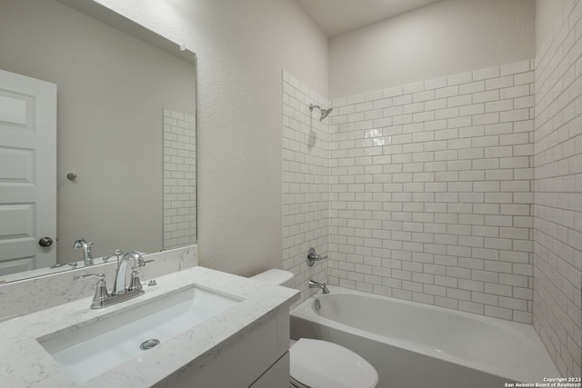 full bathroom featuring tiled shower / bath combo, oversized vanity, and toilet