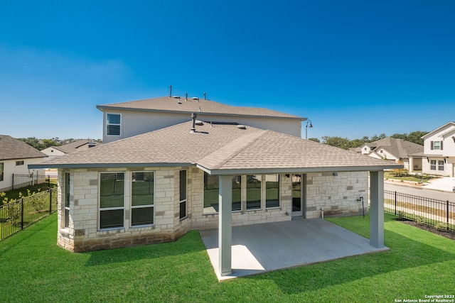 rear view of property featuring a patio area and a yard