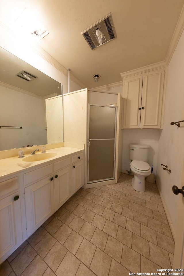 bathroom with tile floors, crown molding, toilet, vanity, and walk in shower